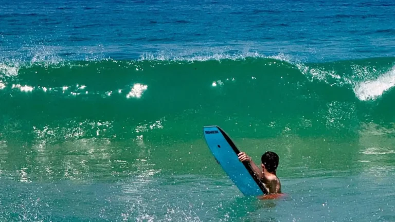 Surfer springt in die glasklaren Wellen des Atlantiks bei Peniche